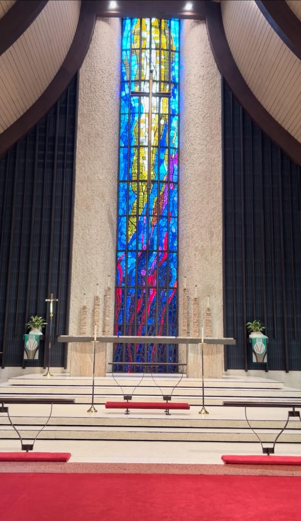 photo of the altar. It shows the marble steps and large colorful stained glass