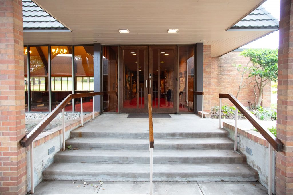 photo of four stairs leading up to glass double doors of the sanctuary